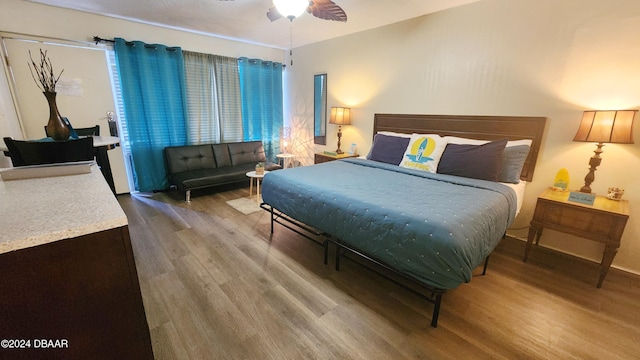 bedroom featuring ceiling fan and hardwood / wood-style flooring