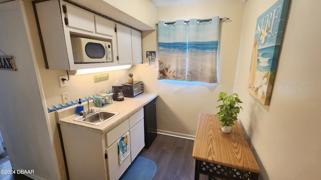 kitchen featuring sink, dark hardwood / wood-style flooring, white cabinets, and dishwasher