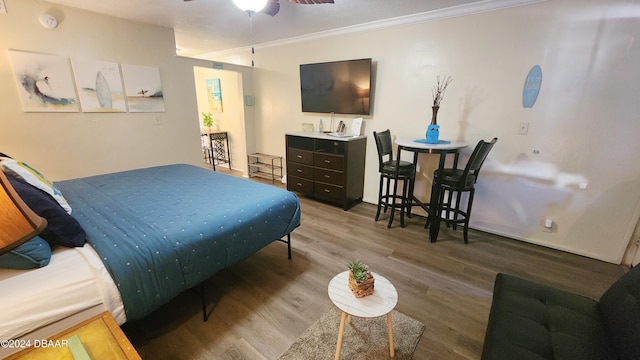 bedroom featuring ornamental molding and hardwood / wood-style floors