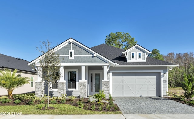 craftsman inspired home featuring a garage and french doors