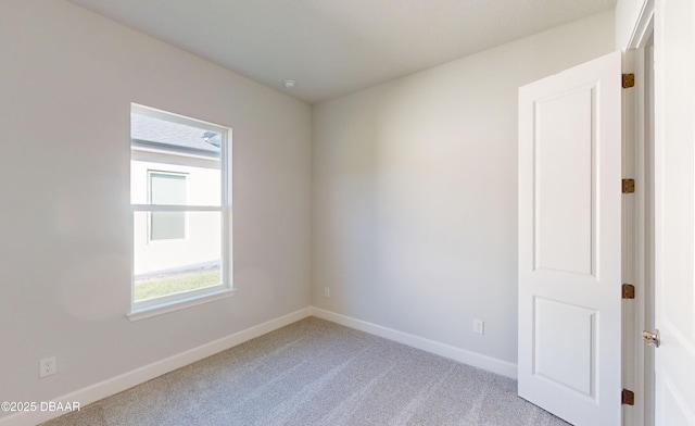 unfurnished room with light colored carpet