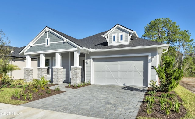 view of front of house with covered porch and a garage