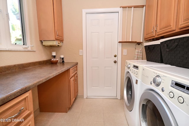 washroom with washer and dryer, light tile patterned floors, and cabinets