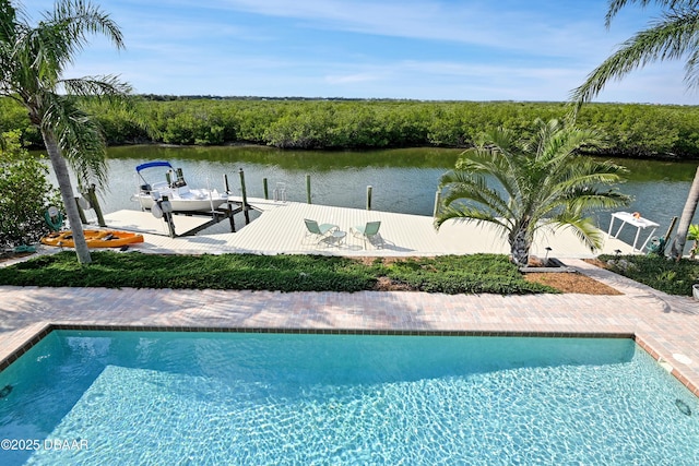 view of swimming pool featuring a dock and a water view