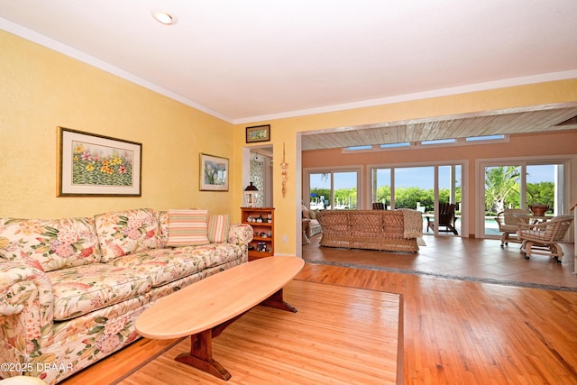 living room with hardwood / wood-style flooring and ornamental molding