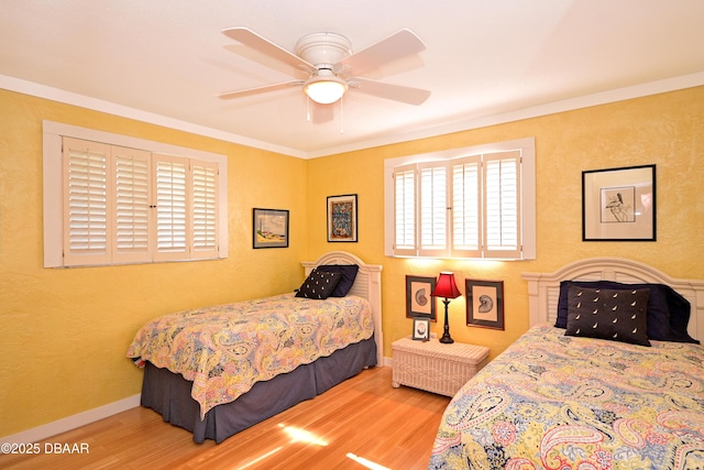 bedroom with hardwood / wood-style flooring, ceiling fan, and crown molding