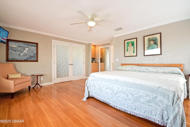 bedroom featuring ceiling fan, light wood-type flooring, french doors, and crown molding