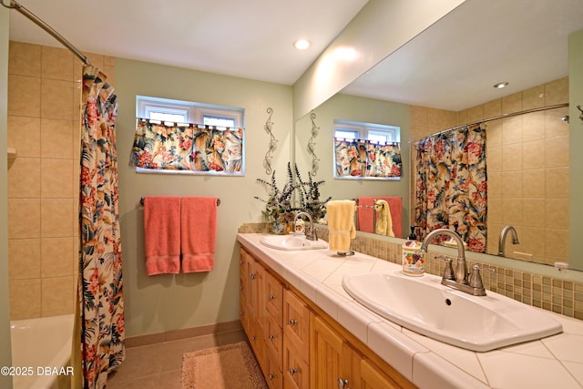 bathroom featuring shower / bathtub combination with curtain, tile patterned floors, and vanity