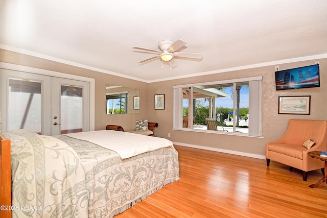 bedroom with french doors, access to exterior, ceiling fan, hardwood / wood-style flooring, and crown molding