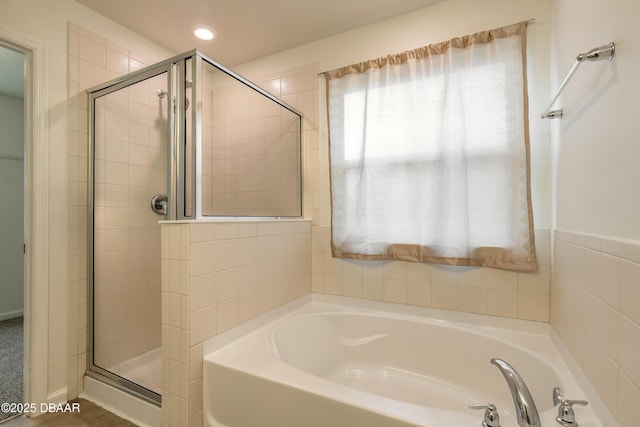 bathroom with a garden tub and a shower stall