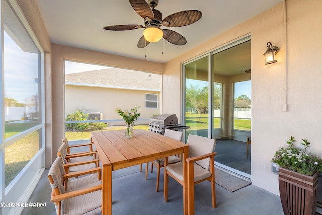 sunroom / solarium with a ceiling fan