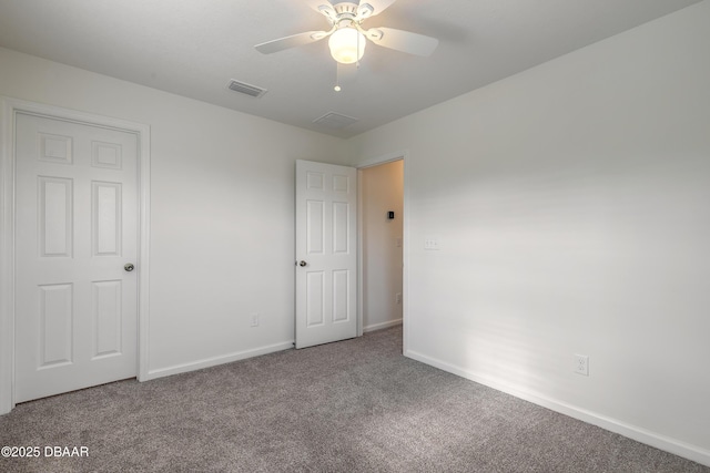 unfurnished bedroom with carpet floors, visible vents, baseboards, and a ceiling fan