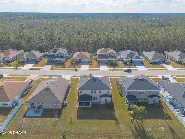 bird's eye view featuring a residential view and a wooded view