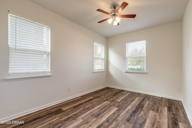 unfurnished room with dark wood finished floors, baseboards, and ceiling fan