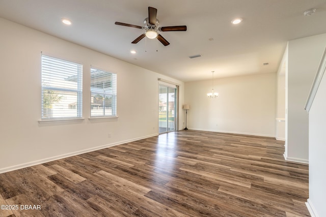 spare room featuring baseboards, dark wood finished floors, visible vents, and recessed lighting