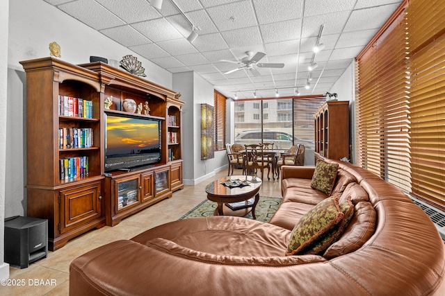 living room featuring light tile patterned flooring, ceiling fan, and rail lighting