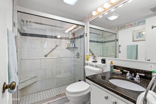 bathroom featuring an enclosed shower, vanity, and toilet