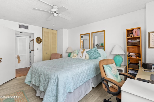 bedroom with ceiling fan, a closet, and a textured ceiling