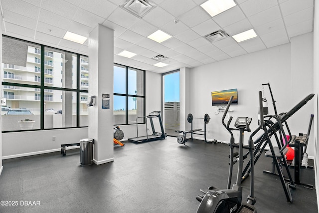 exercise room with a paneled ceiling