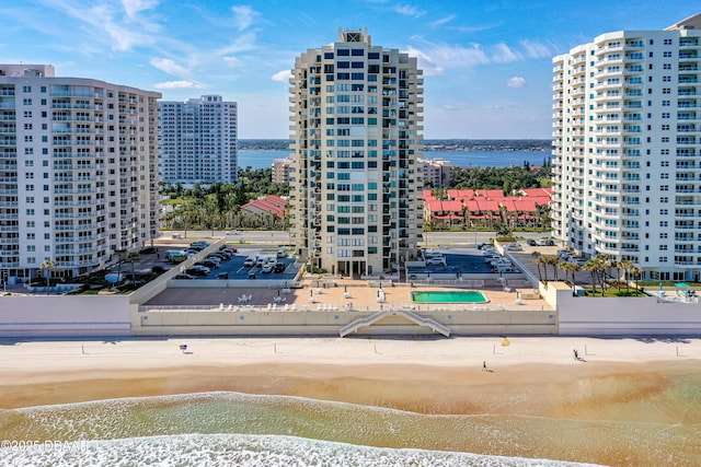 exterior space with a water view and a view of the beach