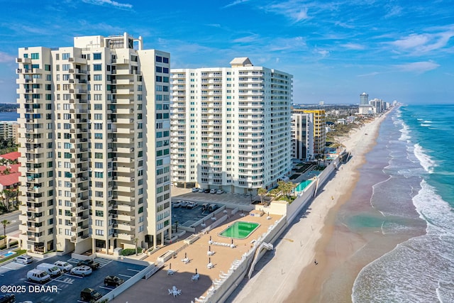 view of property with a water view and a view of the beach