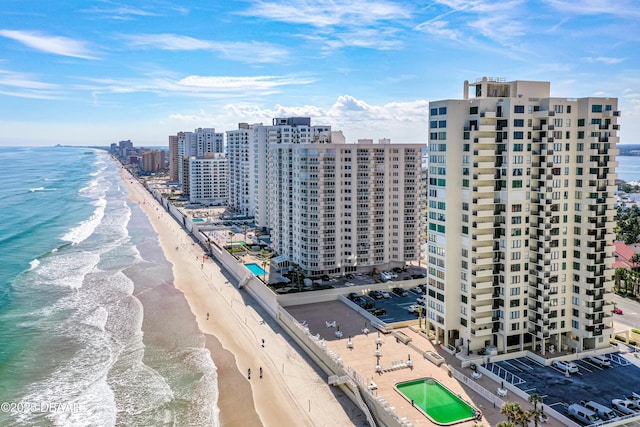 bird's eye view with a water view and a beach view