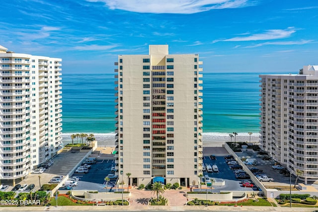 view of property featuring a water view and a beach view