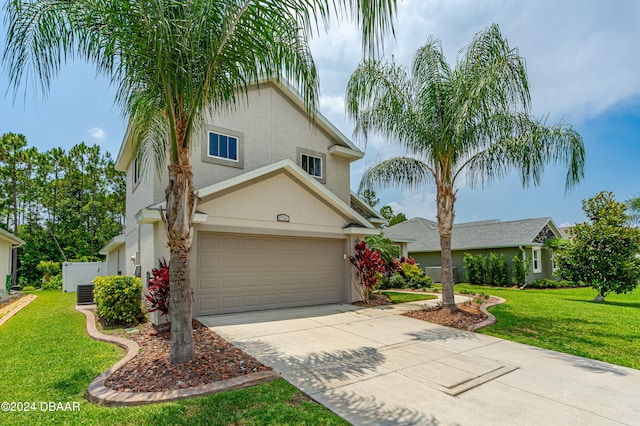 view of front of property with a front yard and a garage