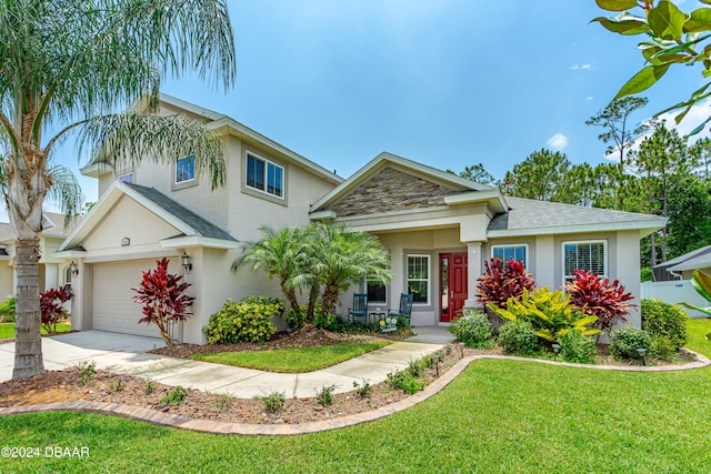 view of front of home with a front yard and a garage