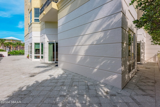 view of side of property featuring a patio area