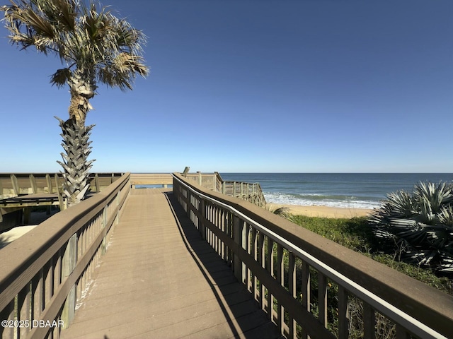 view of home's community featuring a water view and a view of the beach