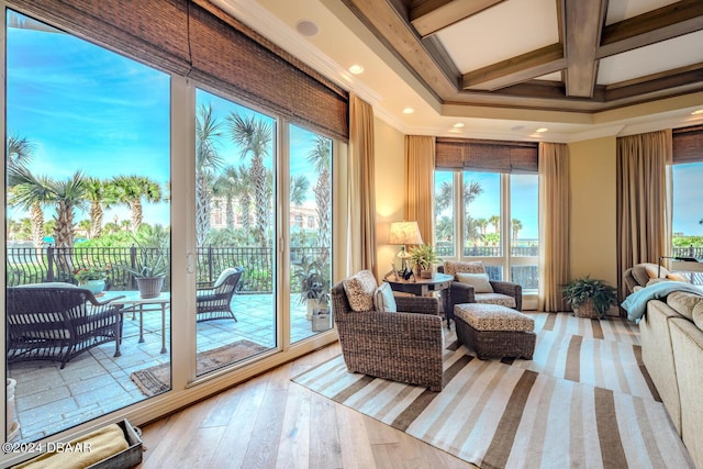 interior space featuring beam ceiling, a wealth of natural light, and coffered ceiling