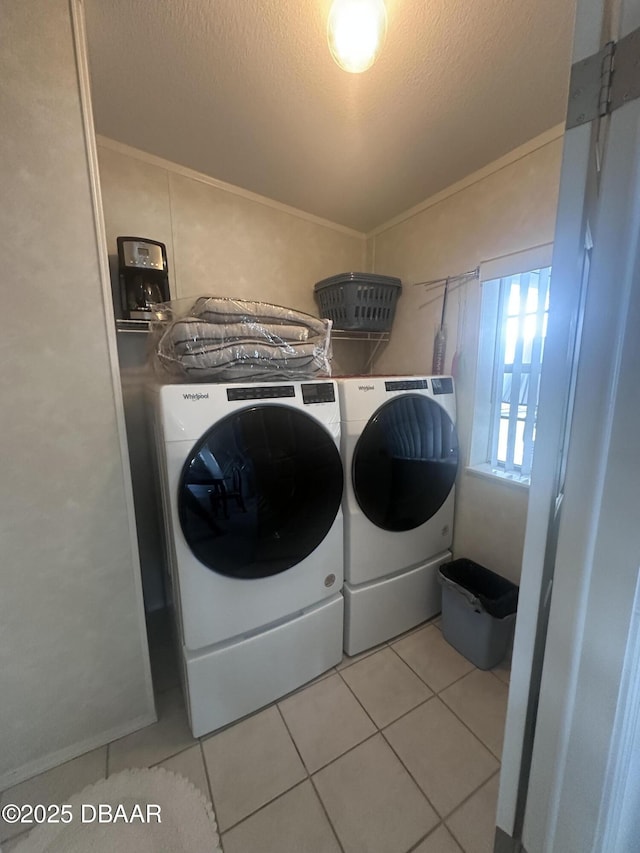 69 Turquoise Ave, Naples, FL 34114 - washroom featuring separate washer and dryer, light tile patterned flooring, and a textured ceiling