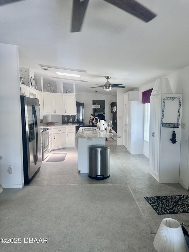 69 Turquoise Ave, Naples, FL 34114 - kitchen featuring appliances with stainless steel finishes, a sink, white cabinets, an island with sink, and ceiling fan