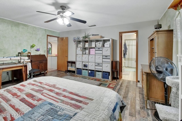 5967 Plantera Ct, Port Orange, FL 32127 - bedroom featuring wood finished floors, ensuite bathroom, and a ceiling fan