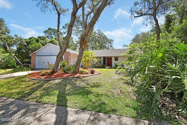 5967 Plantera Ct, Port Orange, FL 32127 - ranch-style home with a garage, brick siding, a front yard, and driveway