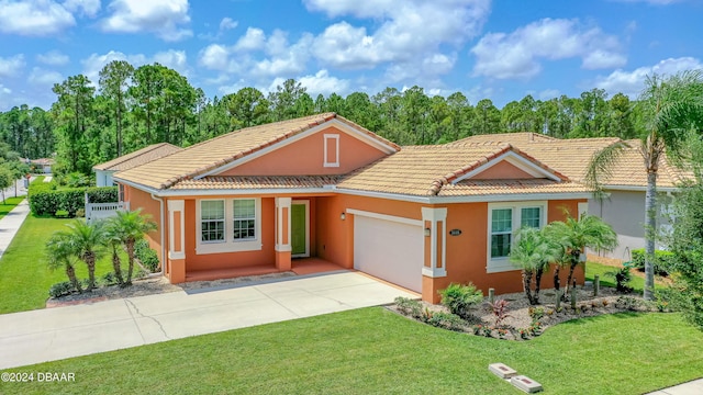 view of front of house featuring a garage and a front lawn