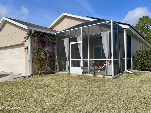 exterior space featuring a garage, a lanai, and a front yard