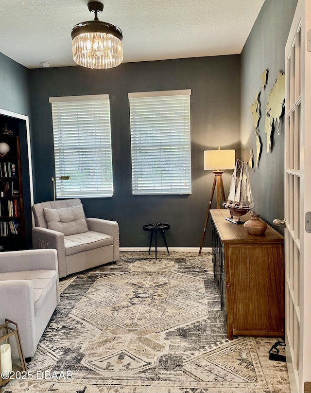 living area featuring a notable chandelier