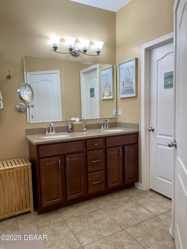 bathroom with tile patterned flooring, vanity, and radiator