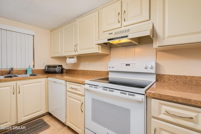 kitchen featuring sink, white appliances, and light tile patterned floors