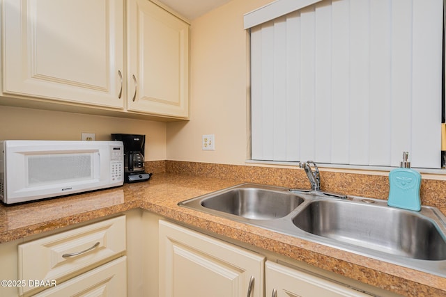 kitchen with sink and cream cabinets