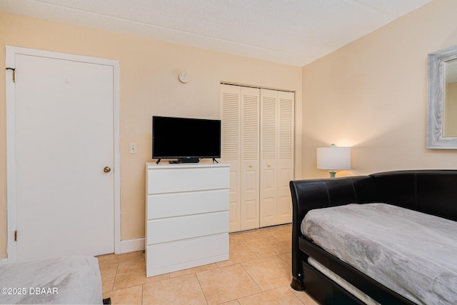 tiled bedroom with a closet