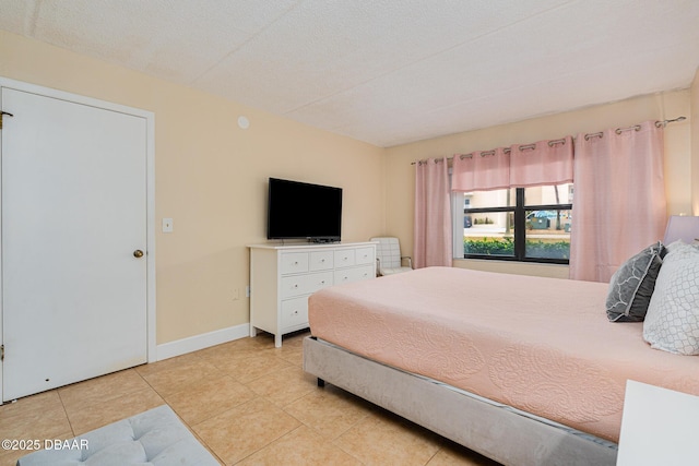 tiled bedroom featuring a textured ceiling