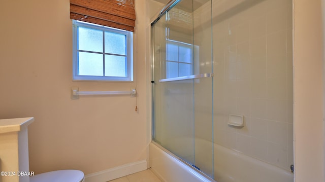 bathroom with toilet, combined bath / shower with glass door, and tile patterned floors