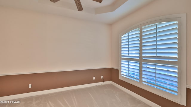 empty room featuring light colored carpet and ceiling fan