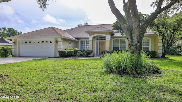 ranch-style home with a front lawn and a garage