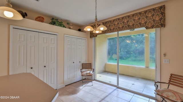 interior space featuring a notable chandelier and light tile patterned floors