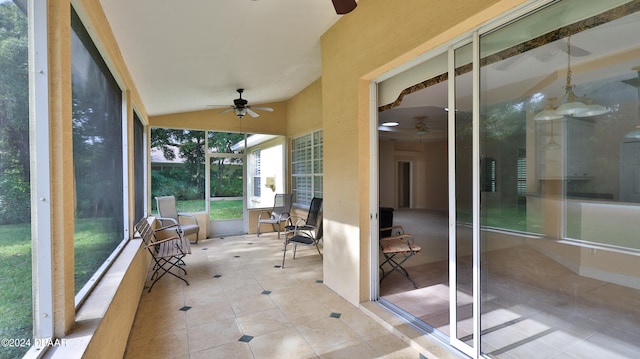 unfurnished sunroom with ceiling fan