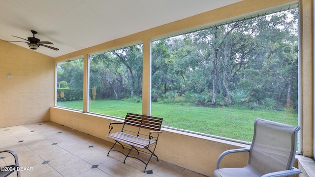 sunroom with lofted ceiling and ceiling fan